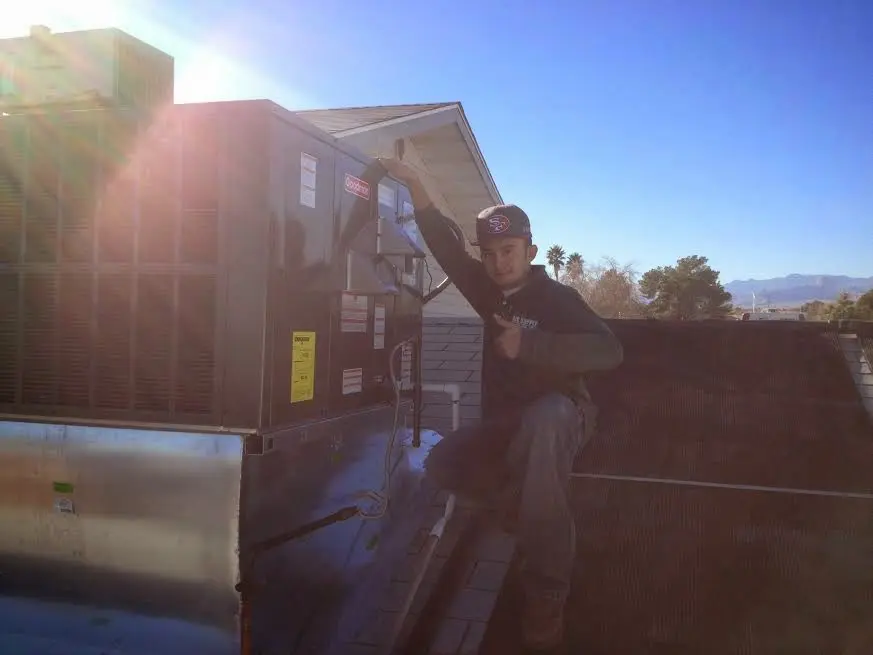 HVAC technician performing HVAC Inspection on a rooftop unit in Mountlake Terrace